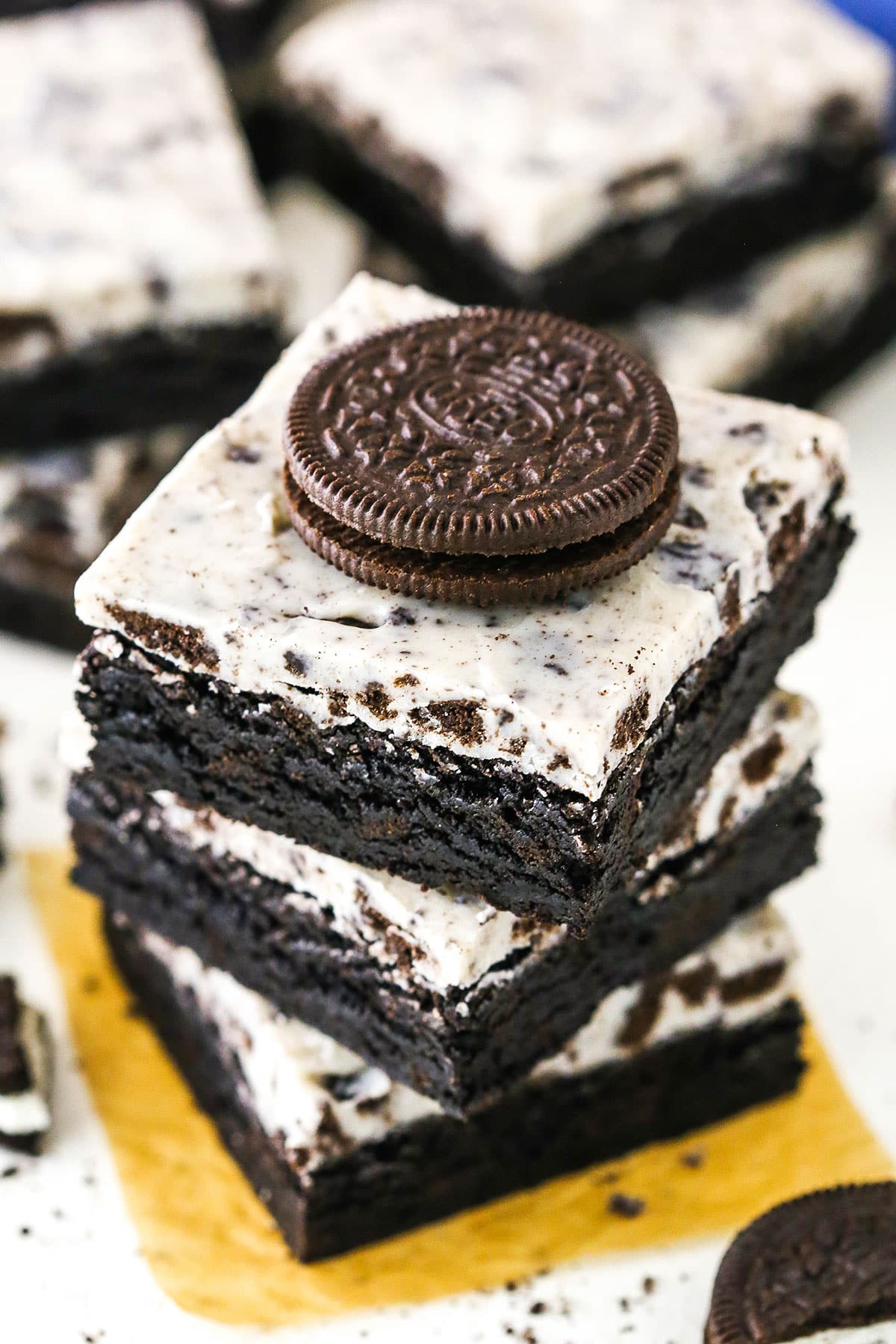 Three Fudgy Cookies and Cream Brownies stacked with an Oreo Cookie on top