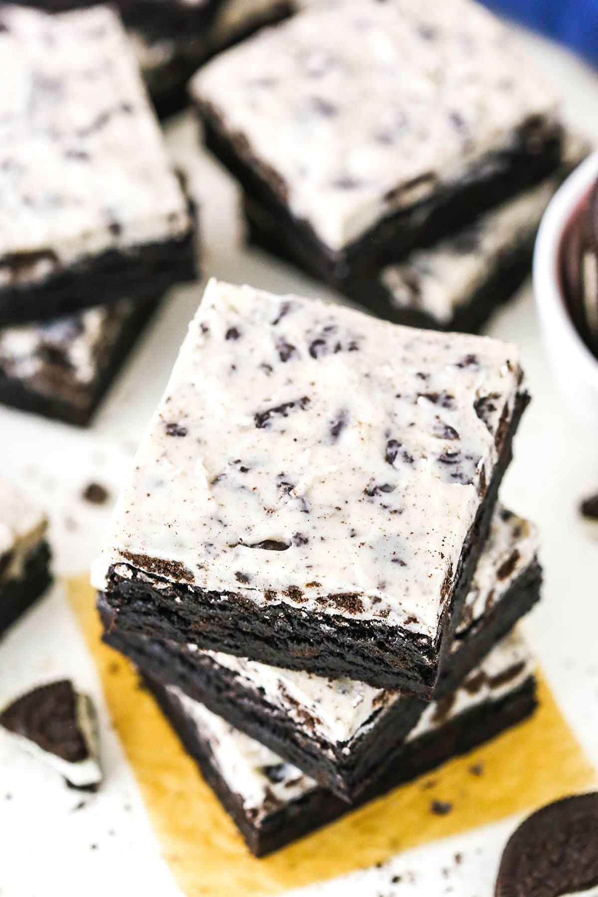 Three Fudgy Cookies and Cream Brownies stacked on a white table