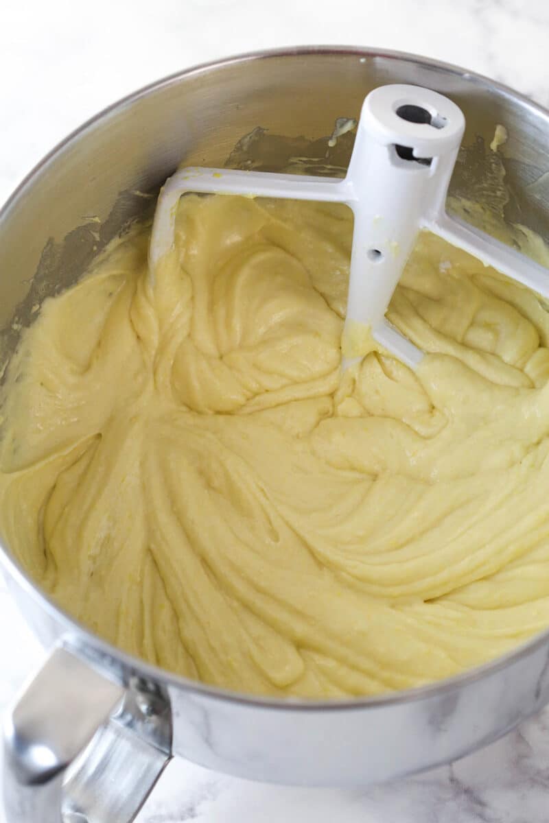 Incorporating wet and dry ingredients for lemon cake batter.
