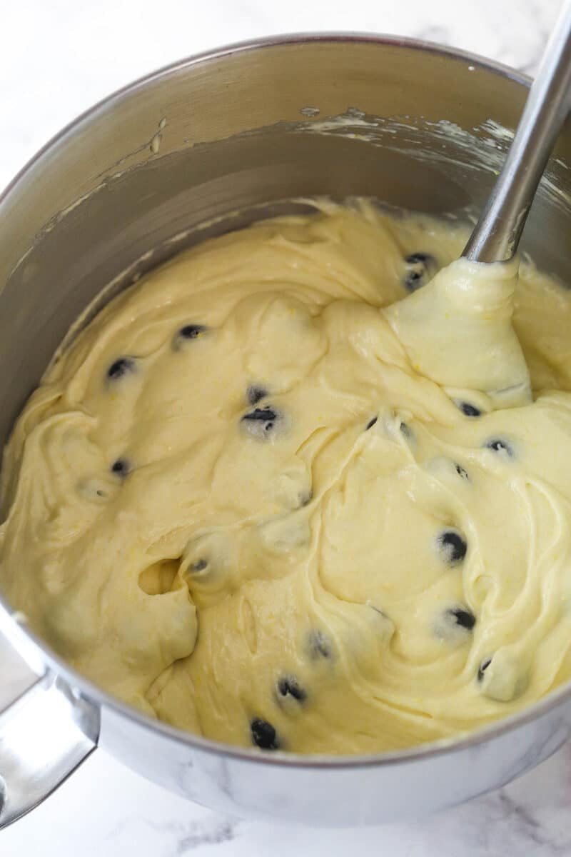 Folding blueberries into lemon cake batter.