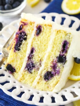 A slice of lemon blueberry cake on a plate.