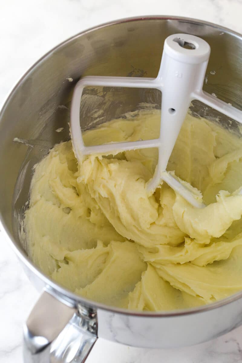 Mixing together cream cheese, sugar, and flour for cheesecake filling.