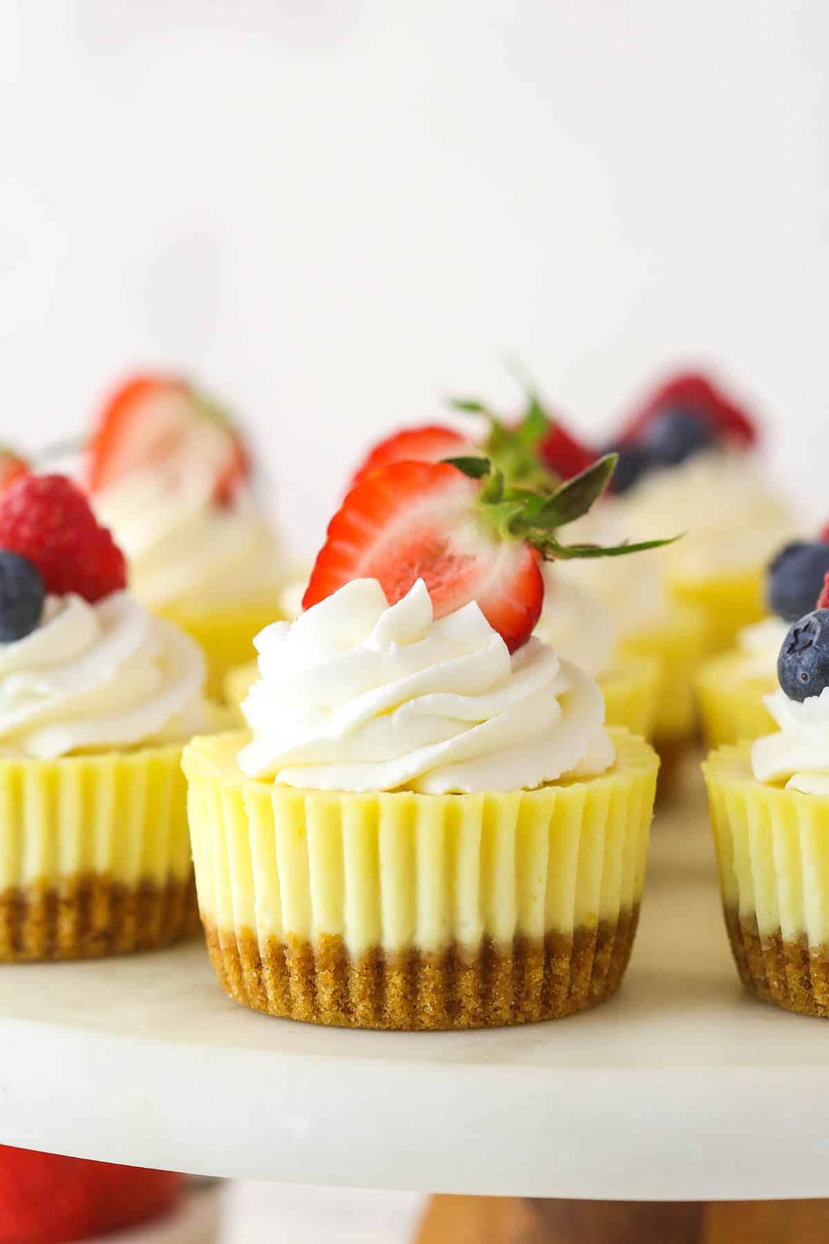 Mini cheesecakes on a cake stand.