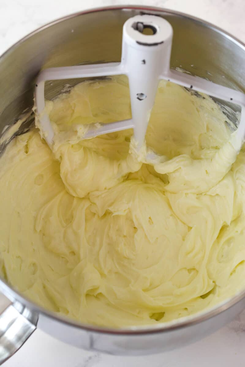 Beating together cream cheese and sugar for cheesecake filling.