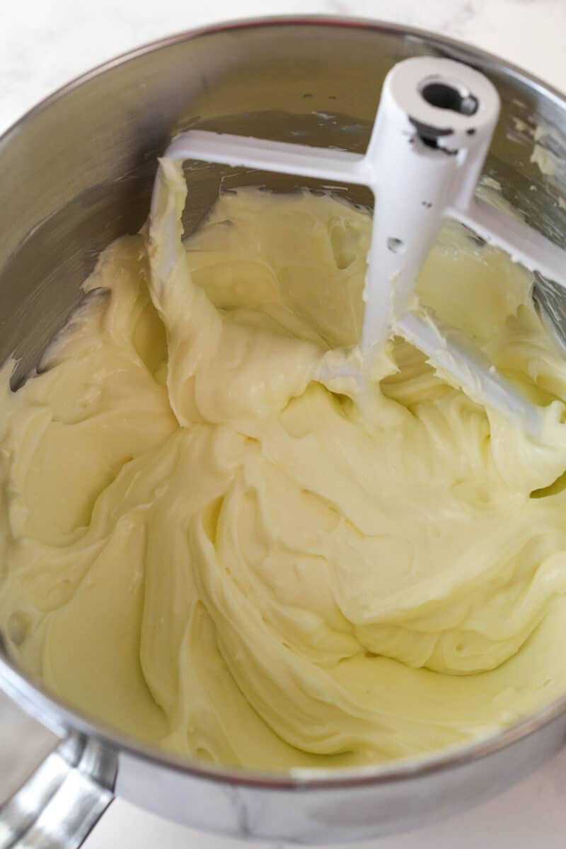 Mixing sour cream and lemon juice into no bake cheesecake filling.