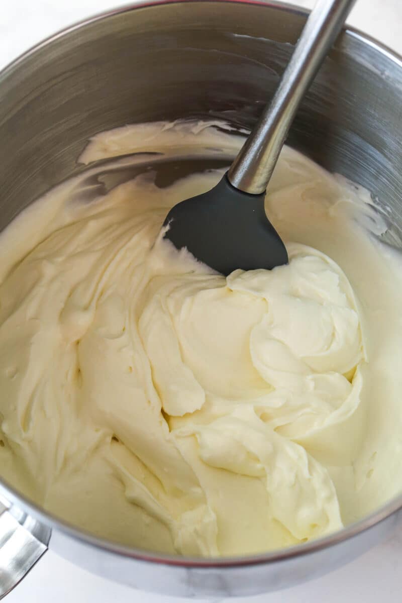 Mixing whipped cream into no bake cheesecake filling.