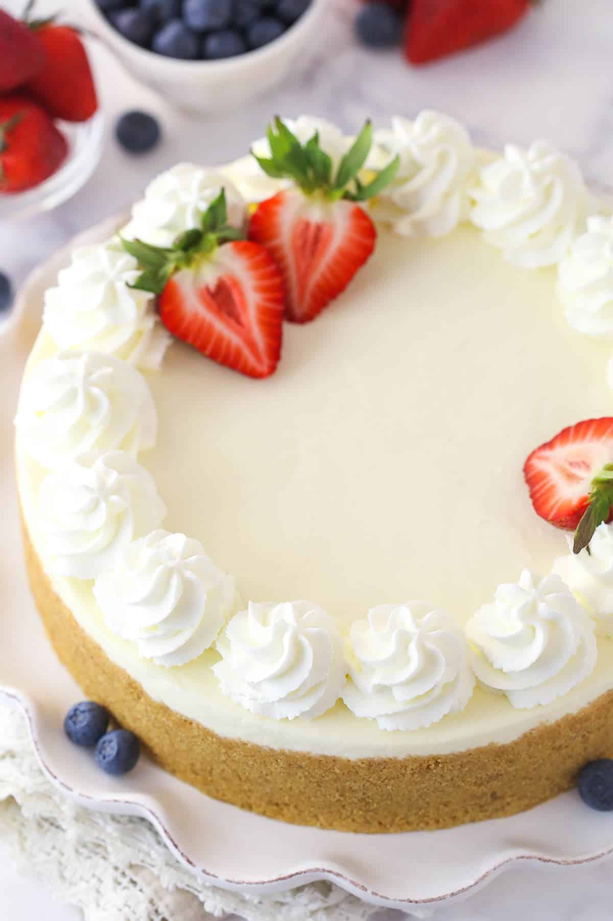 Overhead image of a no bake cheesecake garnished with berries.