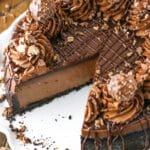 Nutella Cheesecake with a slice removed on a white cake stand