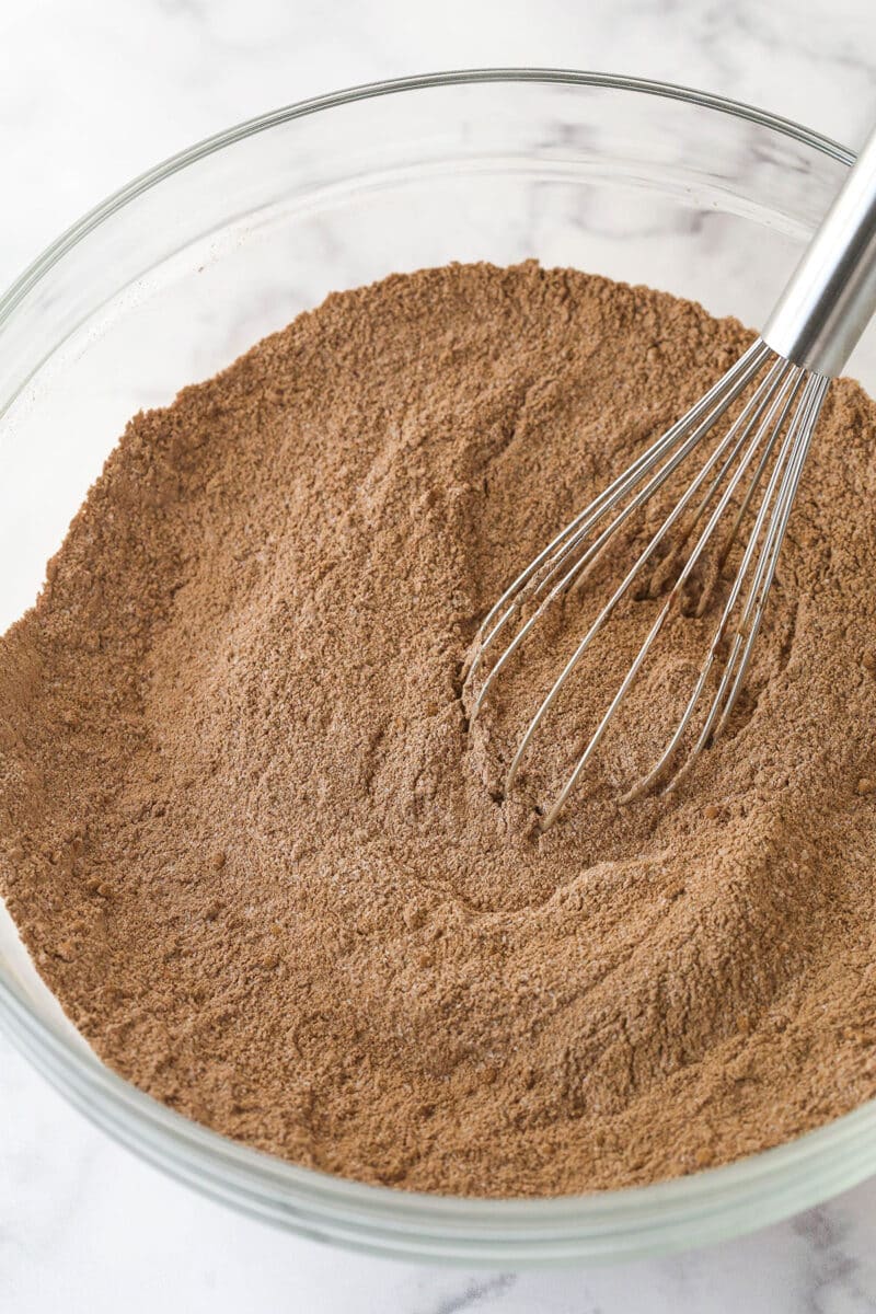 Whisking together dry ingredients for chocolate cake batter.