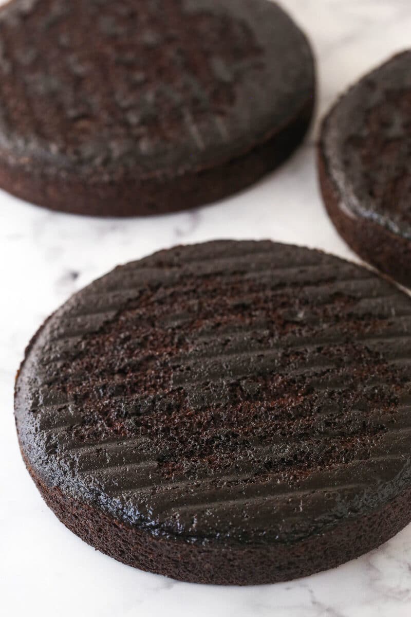 This chocolate raspberry cake is made of moist chocolate cake, smooth raspberry filling, dark chocolate frosting, and rich chocolate ganache. 3 chocolate cake layers ready to be stacked, filled, and frosted.