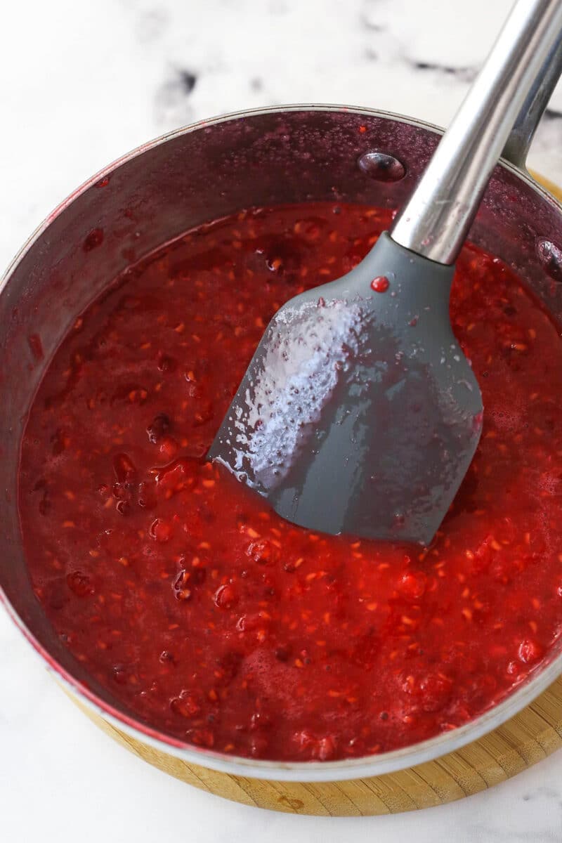 Cooking crushed raspberries with a mixture of melted sugar, water, and cornstarch.
