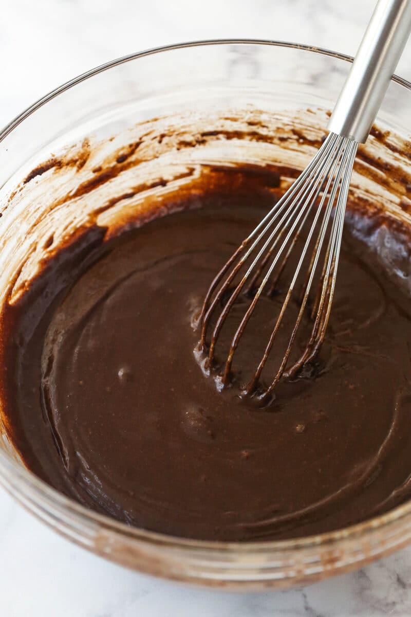 Combining wet and dry ingredients for brownie batter.