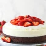 Strawberry brownie cheesecake on a serving platter.