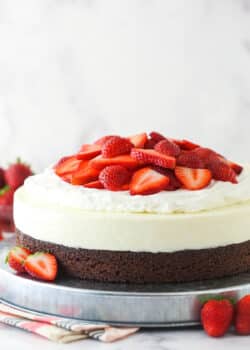 Strawberry brownie cheesecake on a serving platter.