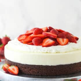 Strawberry brownie cheesecake on a serving platter.
