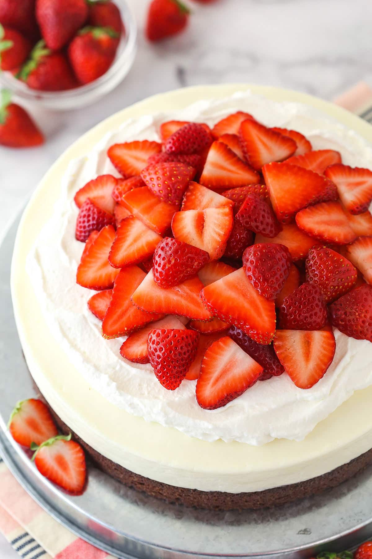 Overhead of strawberry brownie cheesecake on a serving platter.