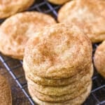 A stack of snickerdoodles on a wire rack.