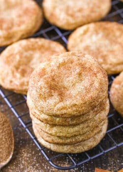 A stack of snickerdoodles on a wire rack.