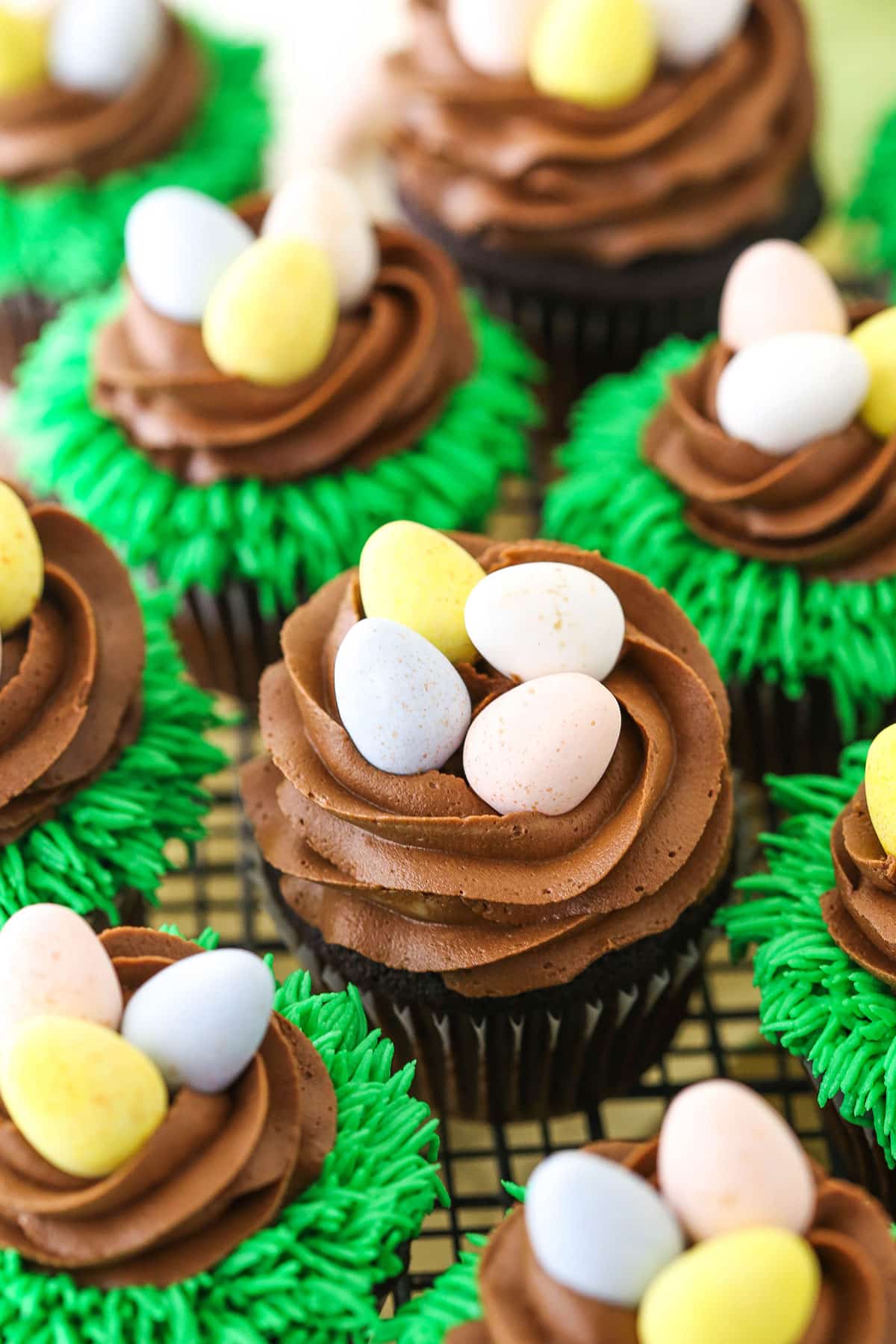 Easter Egg Chocolate Cupcakes on a gray wire cupcake stand