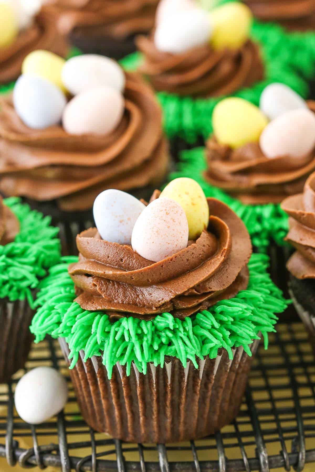 Easter Egg Chocolate Cupcakes on a gray wire cupcake stand