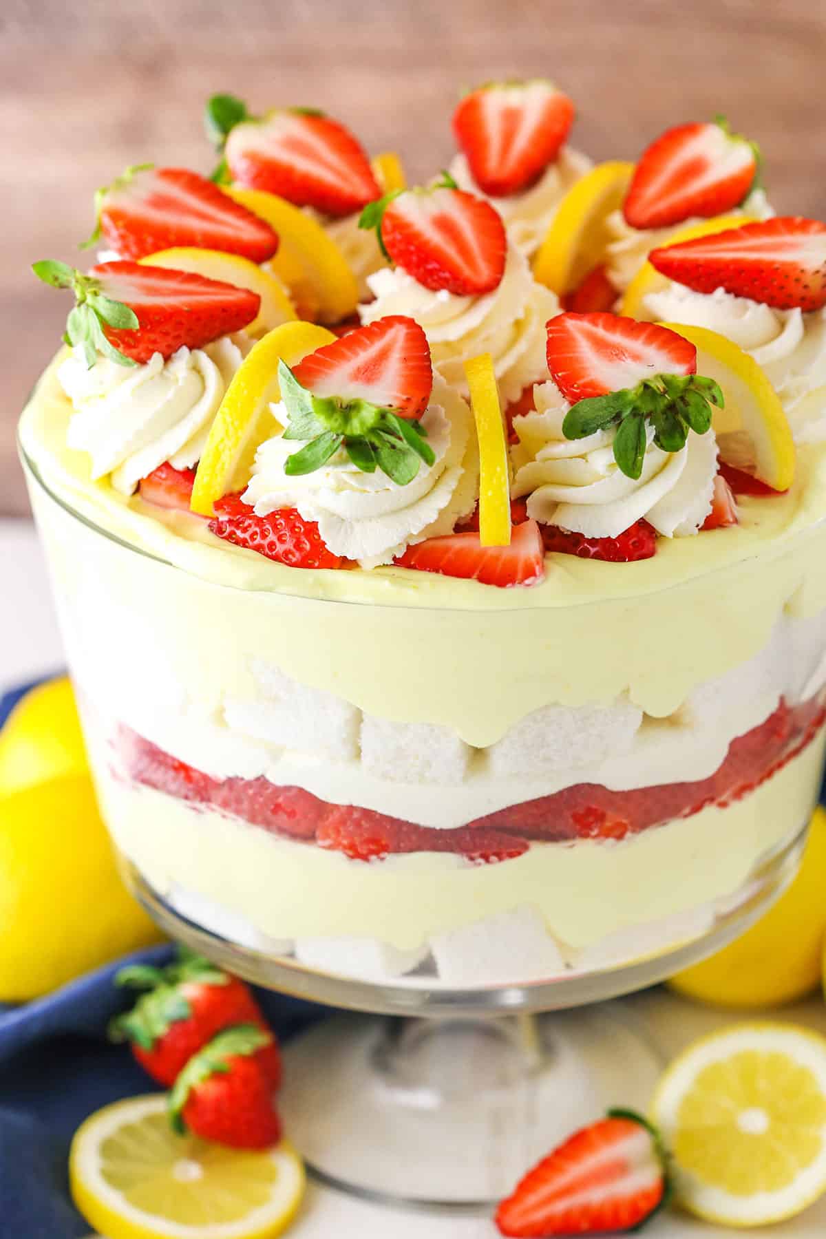 This Easy Lemon Strawberry Trifle is quick to put together with layers of homemade lemon filling, fresh strawberries, mascarpone whipped cream and angel food cake! Such a light dessert that's perfect for potlucks and parties all summer long! Lemon Strawberry Trifle in a clear glass trifle bowl