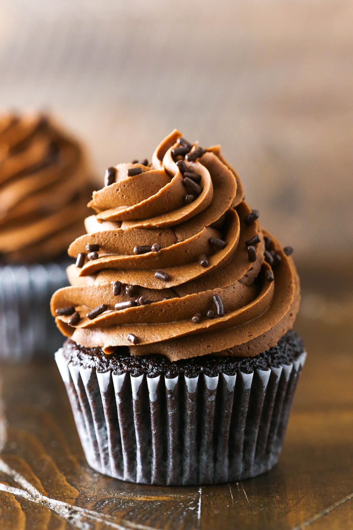 Fudgy Chocolate Buttercream Frosting piped onto a chocolate cupcake