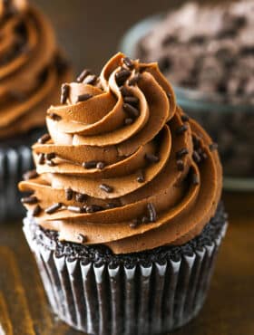 Fudgy Chocolate Buttercream Frosting piped onto a chocolate cupcake