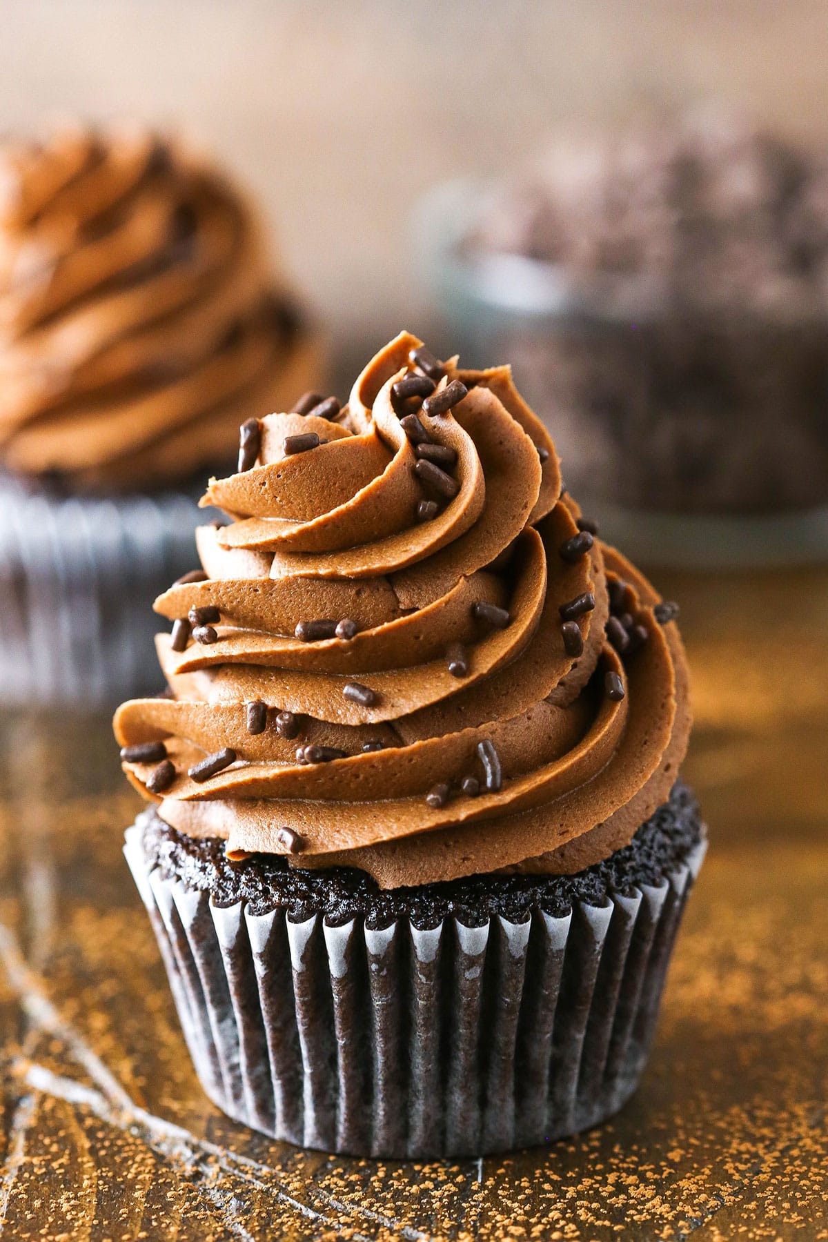 Fudgy Chocolate Buttercream Frosting piped onto a chocolate cupcake