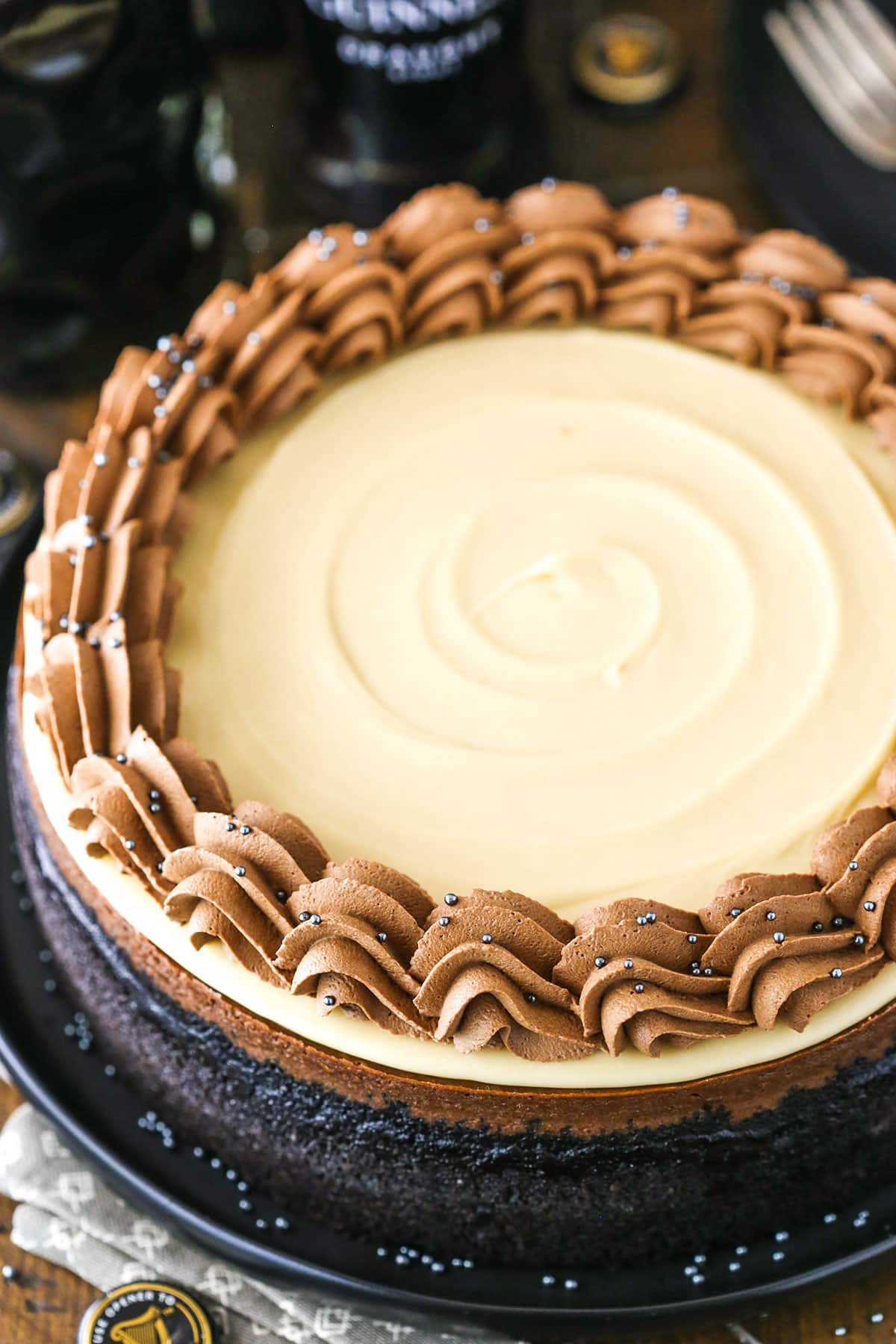 Overhead view of a full Guinness Chocolate Cheesecake on a black plate