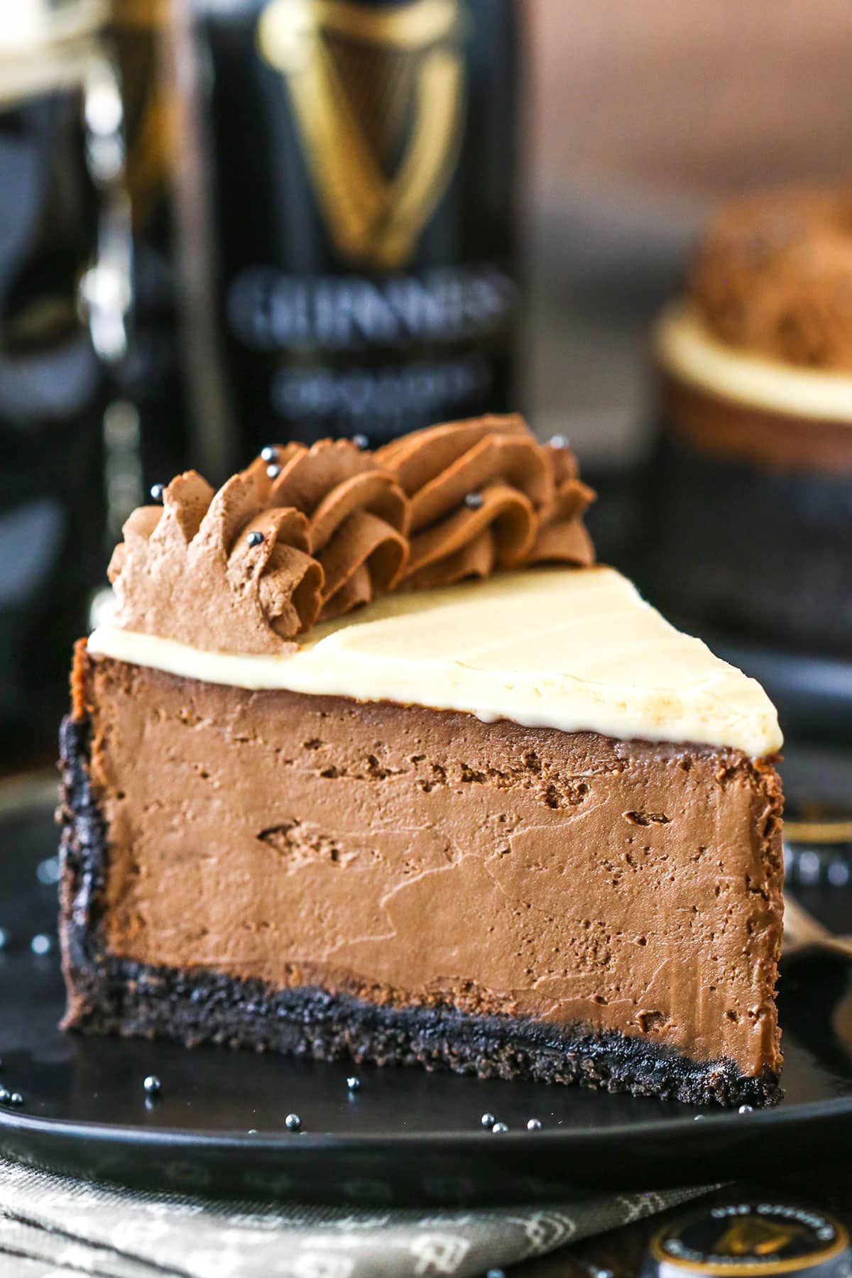 A slice of Guinness Chocolate Cheesecake on a black plate