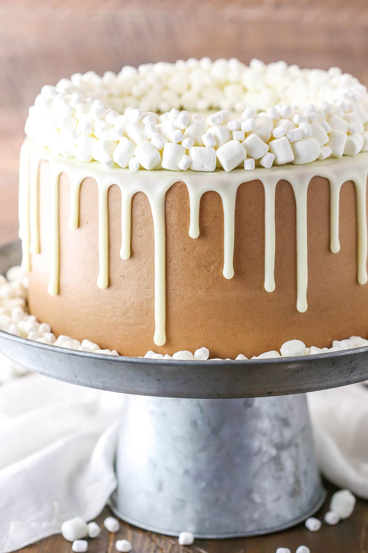 Side view of a full Hot Chocolate Cake on a gray cake stand