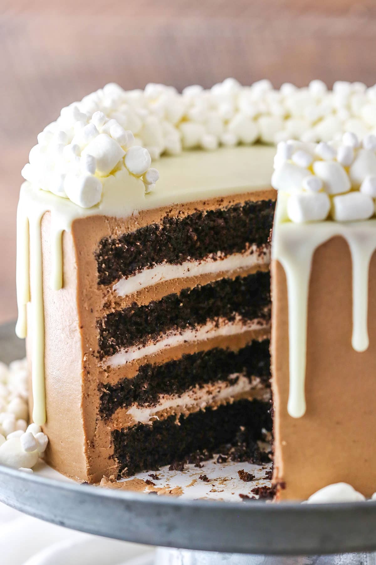 Side view of a Hot Chocolate Cake with a slice removed on a gray cake stand