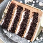 A slice of Hot Chocolate Cake next to a silver fork on a gray plate