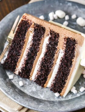 A slice of Hot Chocolate Cake next to a silver fork on a gray plate