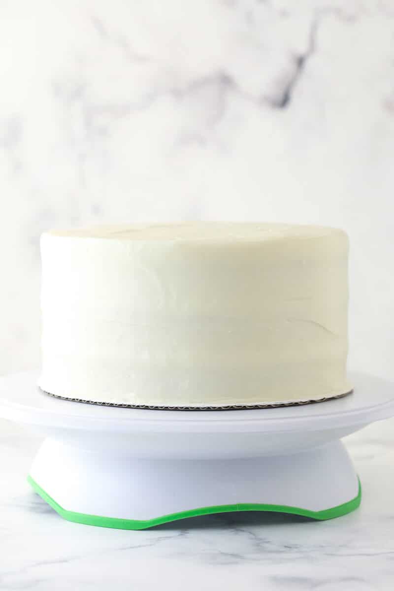 Frosted cake on a cake stand.