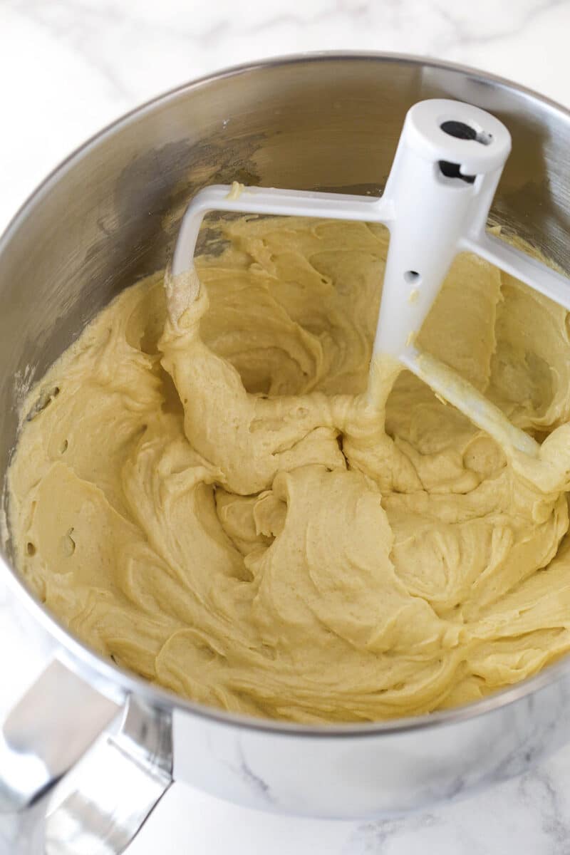 Adding eggs to cake batter.