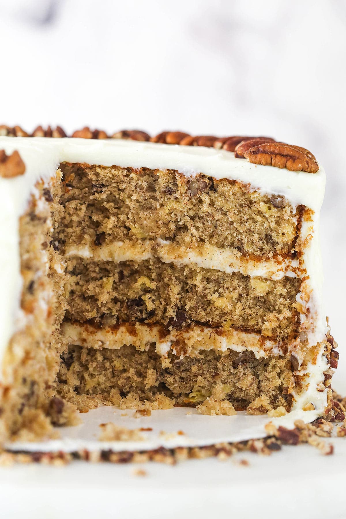 Hummingbird cake with a slice taken out of it.