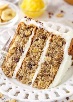 A slice of hummingbird cake on a plate with a fork.