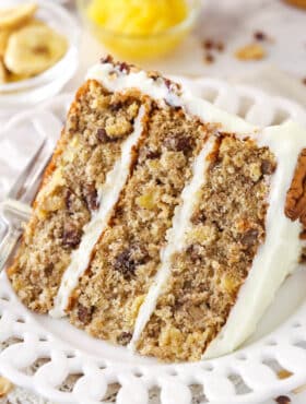 A slice of hummingbird cake on a plate with a fork.