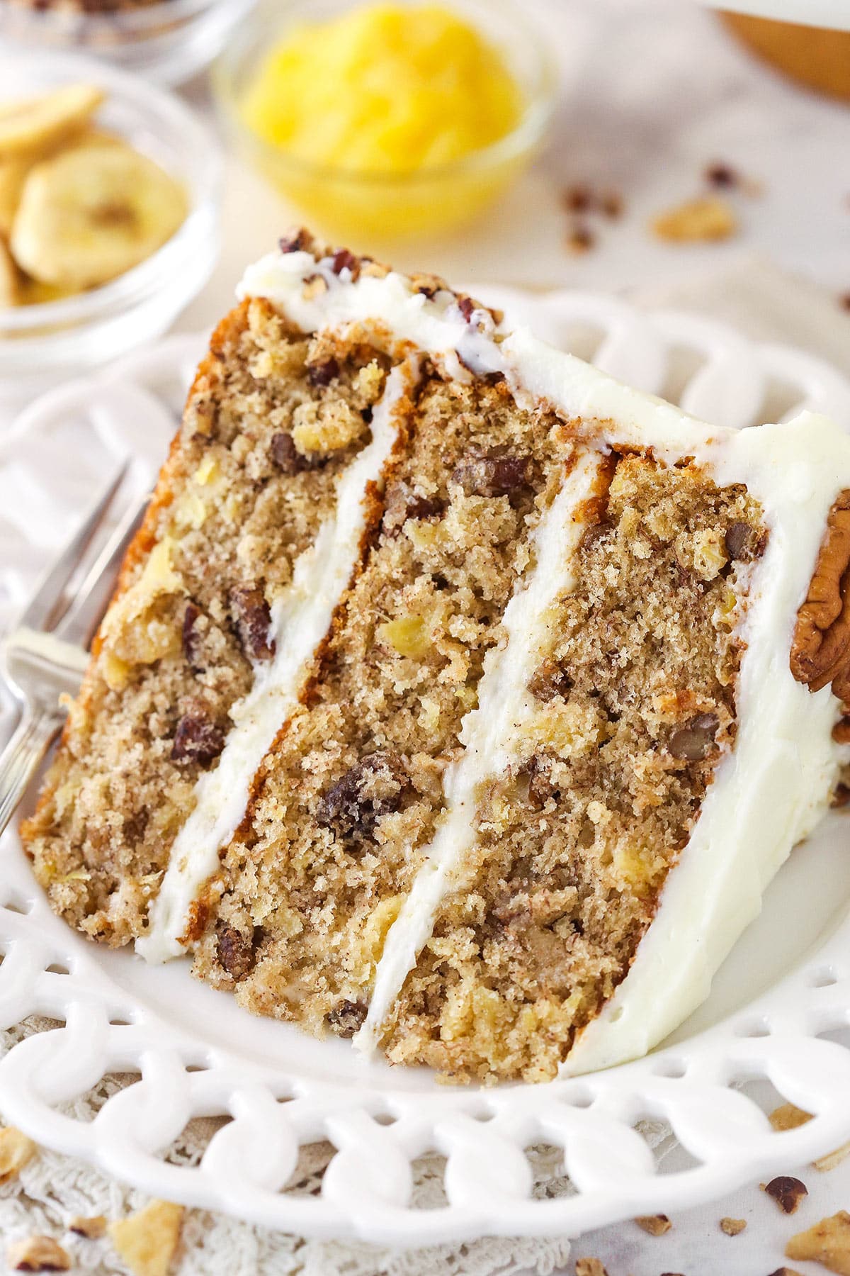 A slice of hummingbird cake on a plate with a fork.