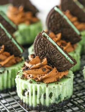 Side view of Mini Mint Chocolate Oreo Cheesecakes on a gray metal stand