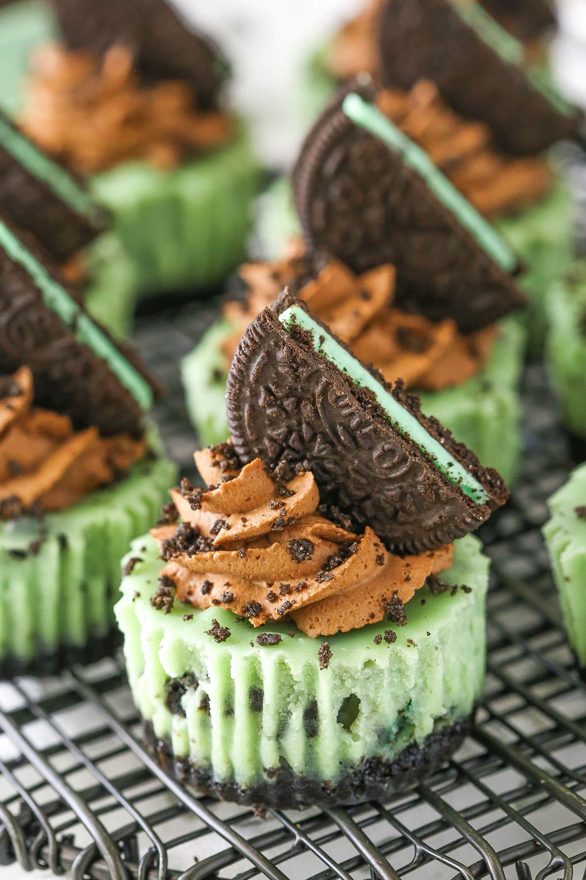 Mini Mint Chocolate Oreo Cheesecakes on a gray metal stand