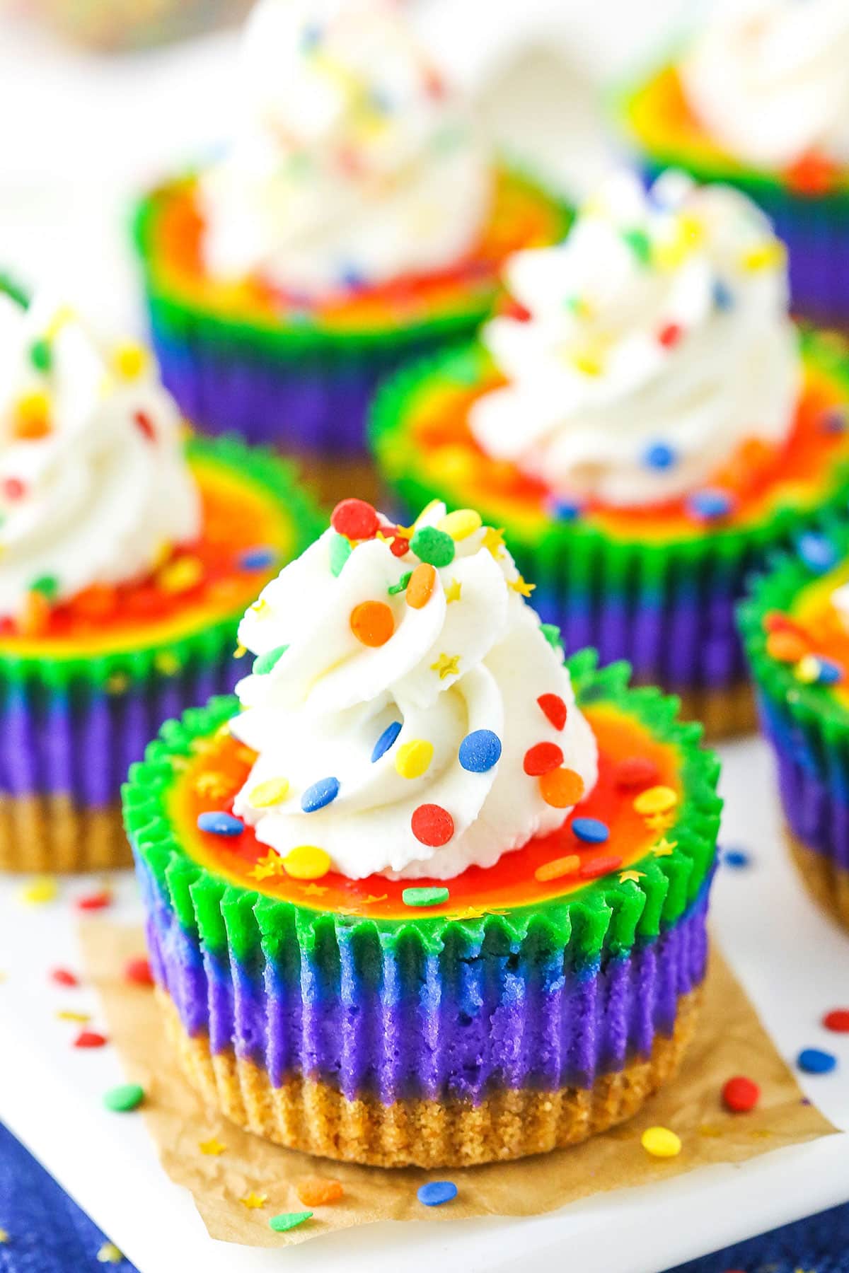 Mini Rainbow Cheesecakes on a white serving tray