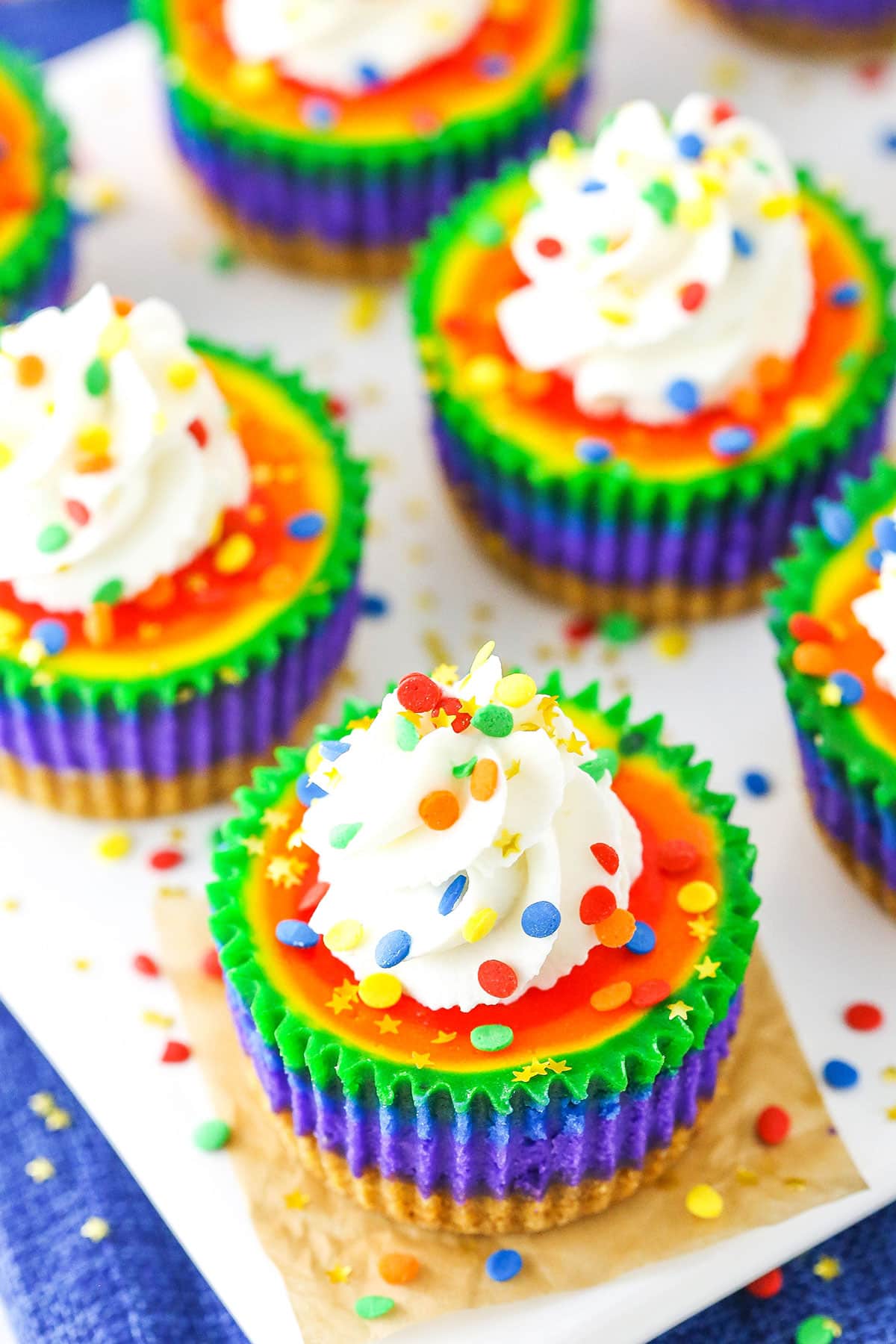 Mini Rainbow Cheesecakes on a white serving tray