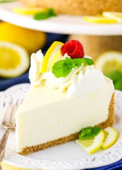 A slice of No Bake Lemon Cheesecake next to a silver fork on a white plate