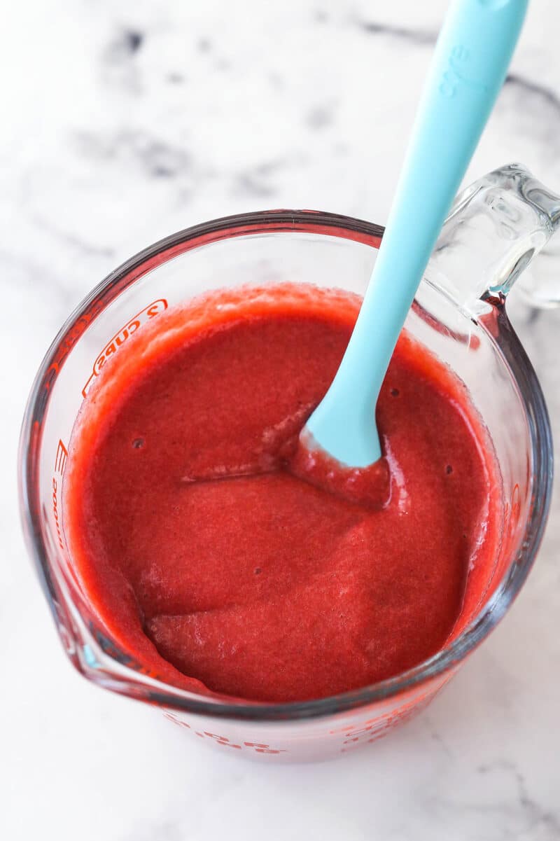 reduced strawberry puree in a glass measuring cup