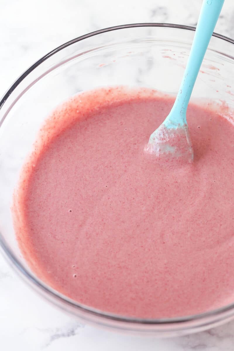 mixture of sweetened condensed milk, strawberry reduction and vanilla extract in a glass bowl