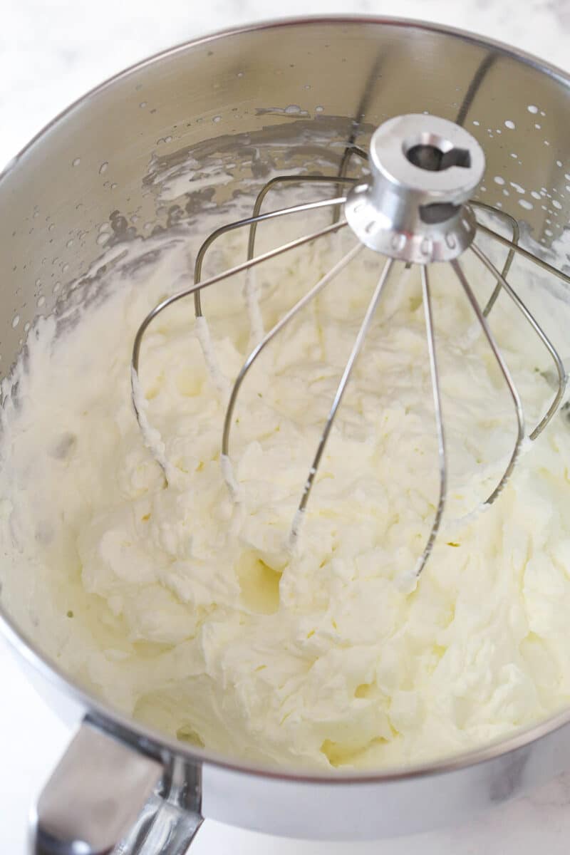 whipped cream in a metal mixing bowl