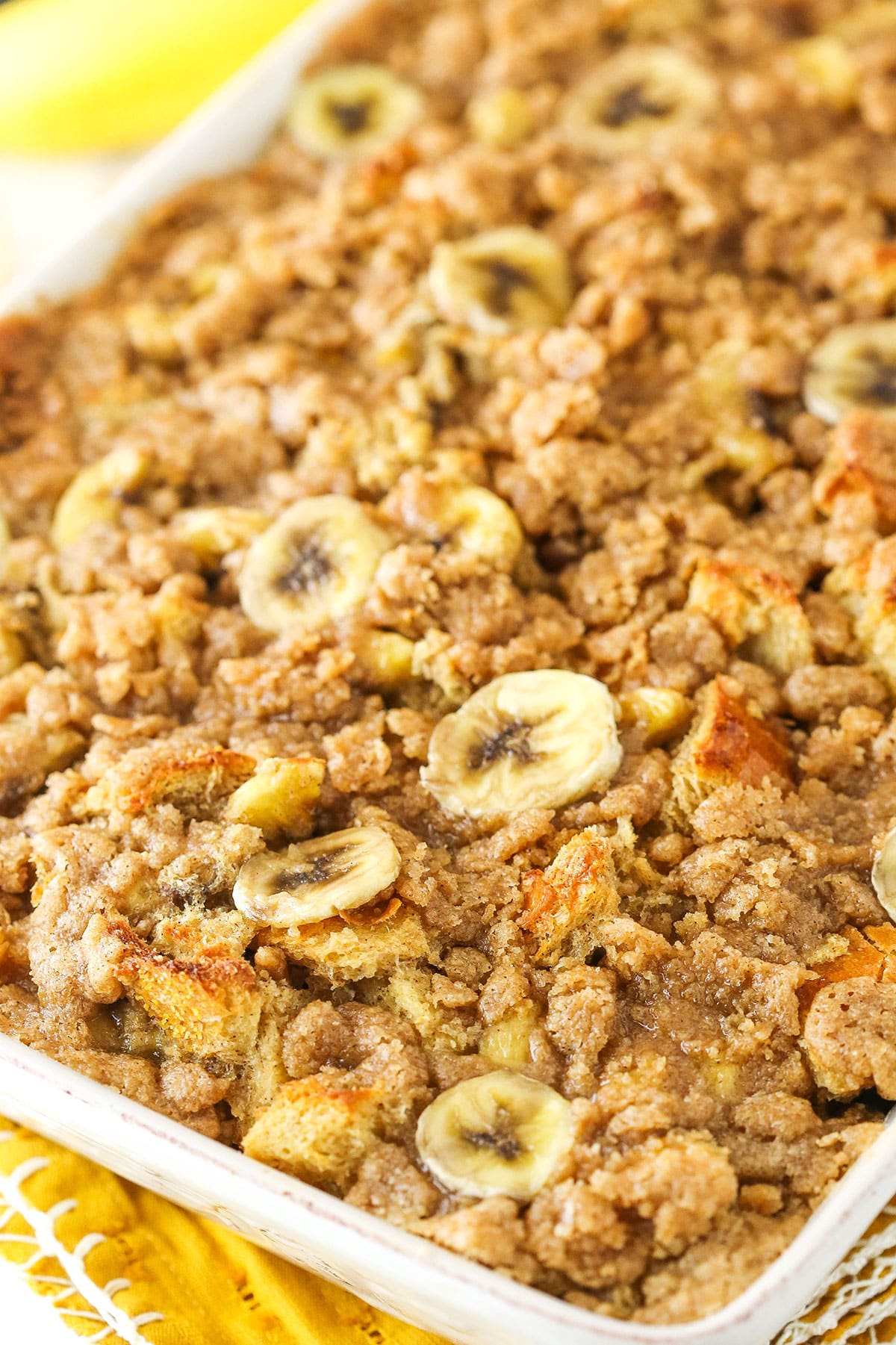 Overnight Baked Banana French Toast Casserole in a white serving tray