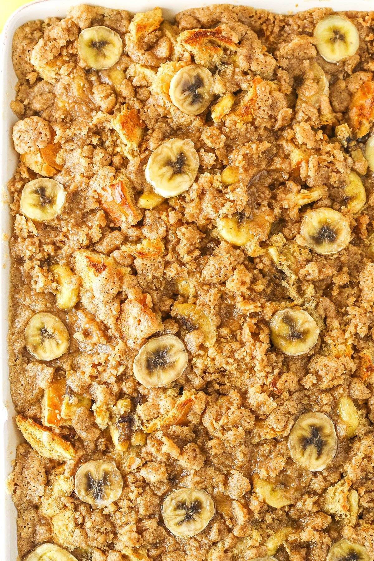 Overnight Baked Banana French Toast Casserole in a white serving tray